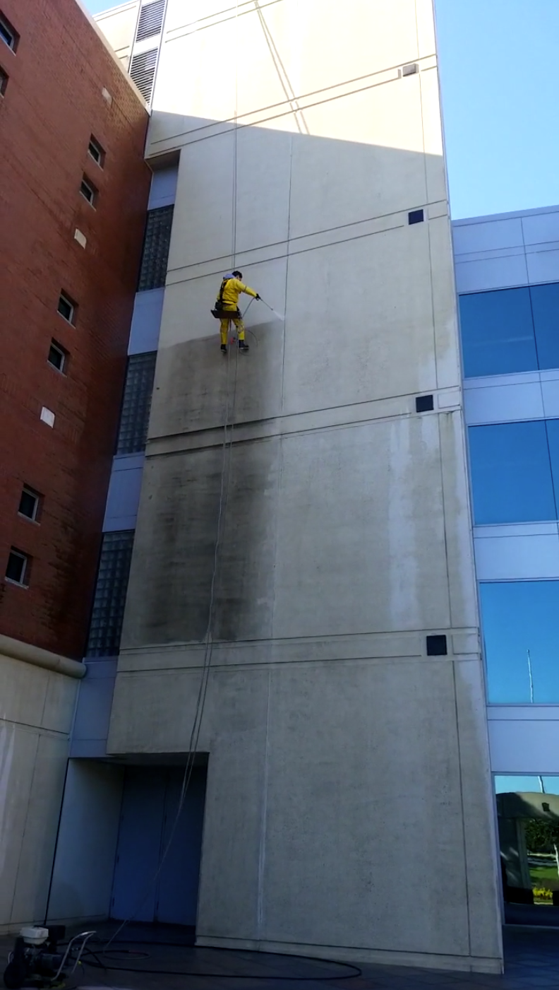 Close-up view of commercial building facade during cleaning