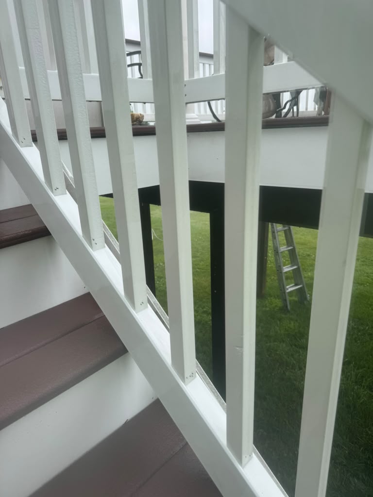 Clean white residential deck railing after exterior cleaning in Maryland.