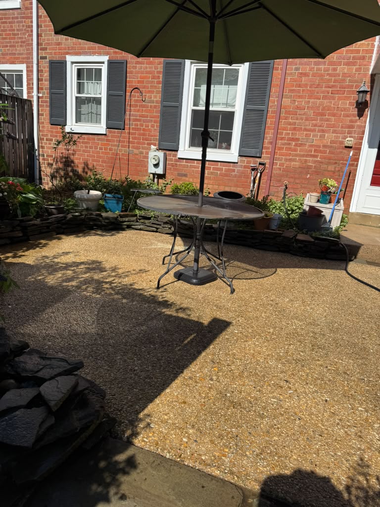 Residential exposed-aggregate patio after pressure washing in Northern Virginia.