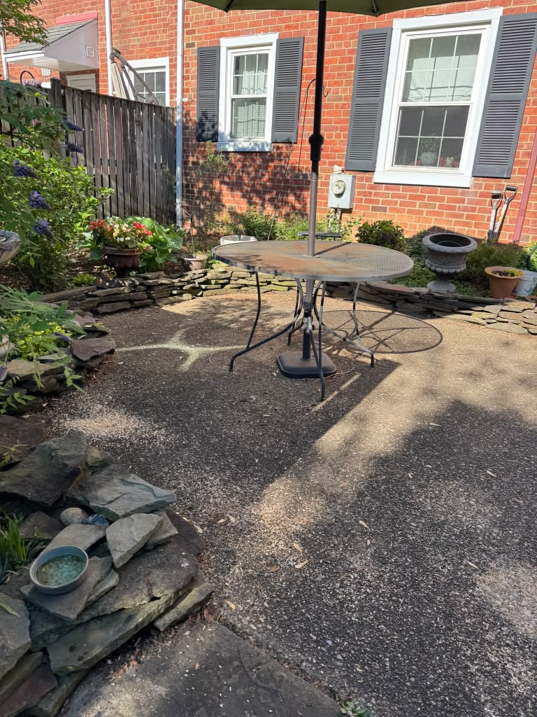 Residential exposed-aggregate patio before cleaning in Northern Virginia.