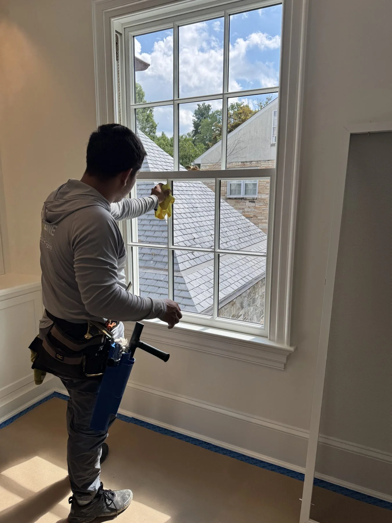 Top of the Line technician detailing the inside of a residential window