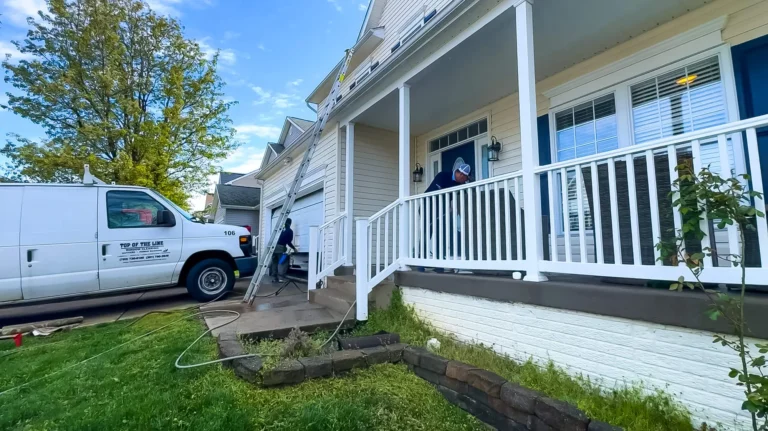 Top of the Line residential window cleaning crew arriving at a home with a service van