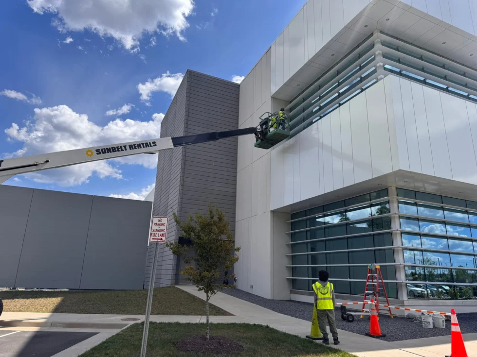 Window cleaning crew using a boom lift at a commercial building